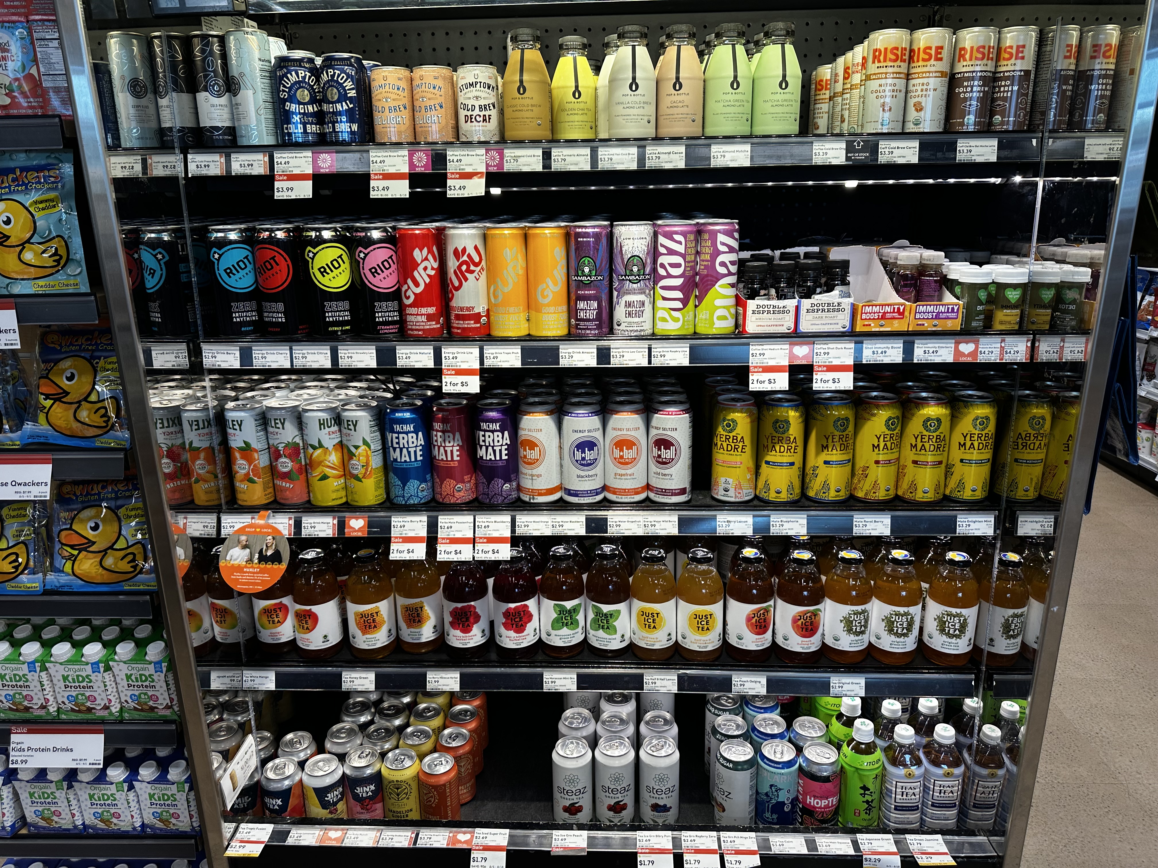 The refrigerated drink case at the grocery store, filled with coffee